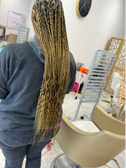 Long blonde box braids with curly ends