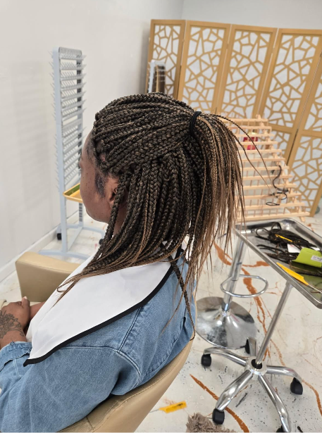 Brown box braids in a ponytail